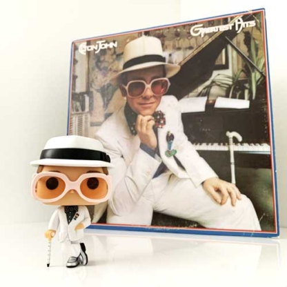 Elton John Greatest Hits Funko Pop Rocks Vinyl Figure in front of Elton John's 1974 Album